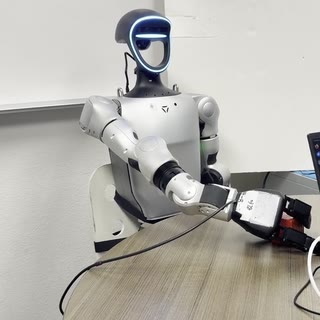 Unitree G1 humanoid grasping a block